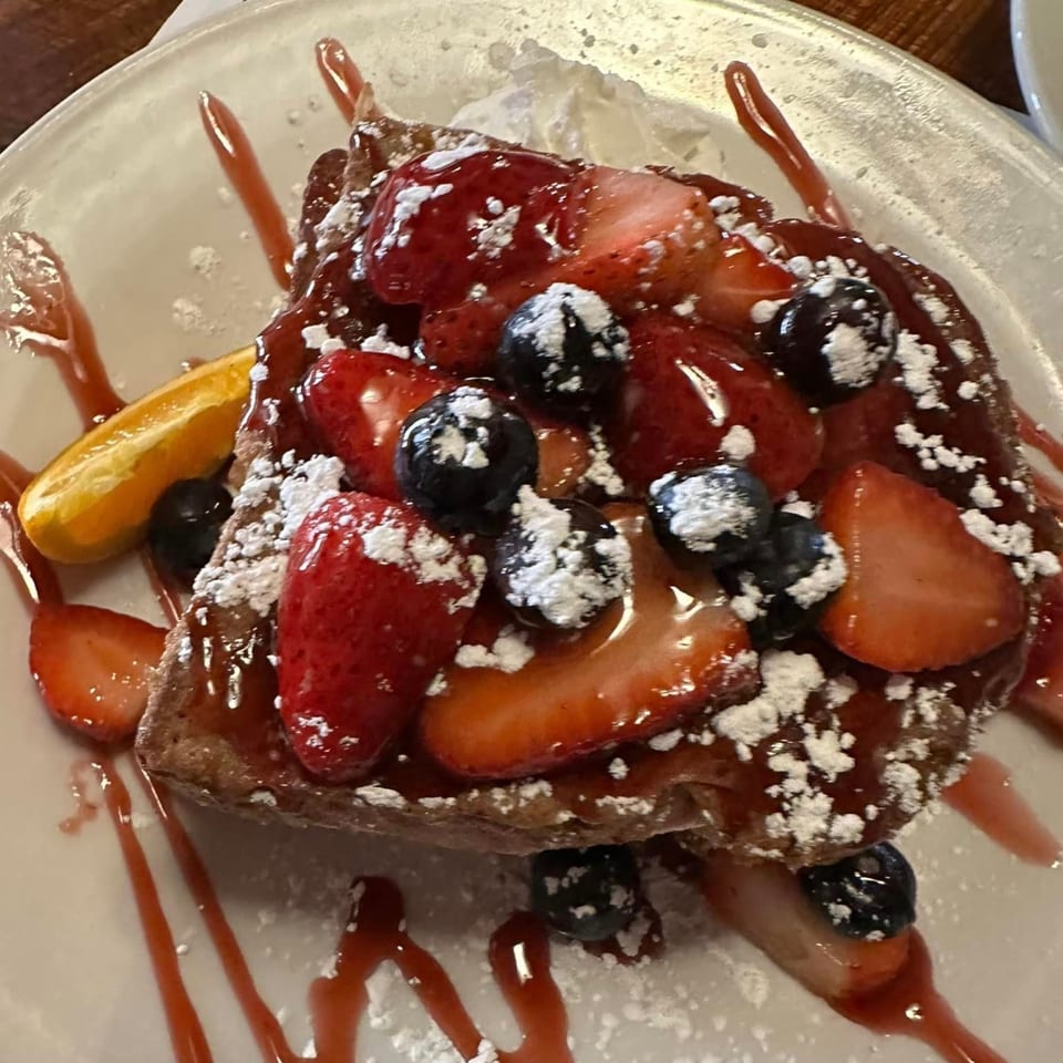 French toast topped with strawberries, blueberries, powdered sugar, and strawberry syrup at Chef Darrell's Mountain Diner.