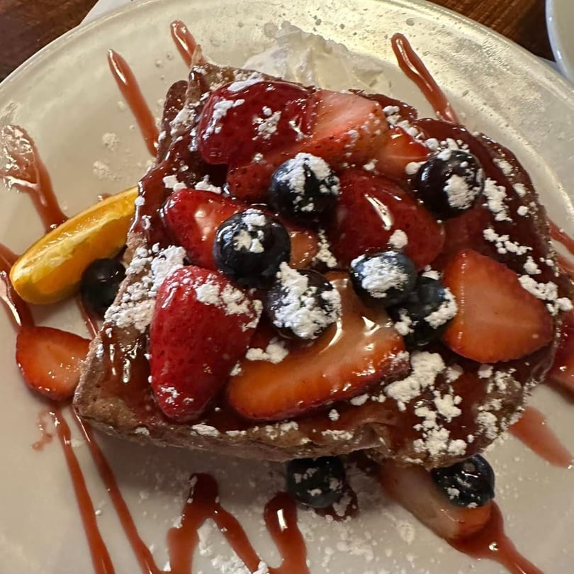 French toast topped with strawberries, blueberries, powdered sugar, and strawberry syrup at Chef Darrell's Mountain Diner.